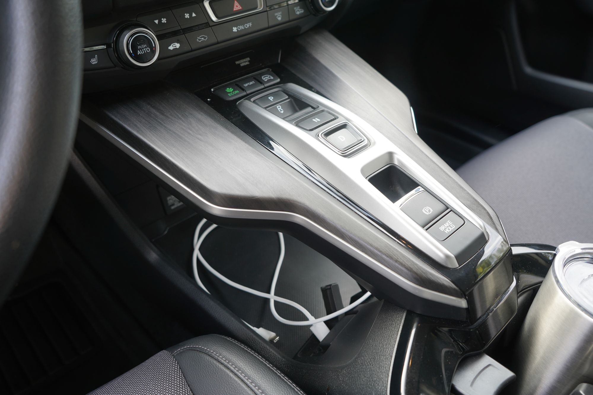 Shelf and shifter arrangement in the center console